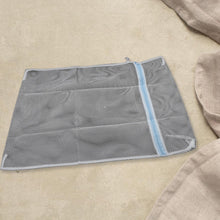 Mesh laundry bag with premium zipper, ideal for washing delicates and organizing.