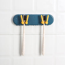 Plastic organizer with hooks, wall-mounted for bathroom and kitchen accessories.