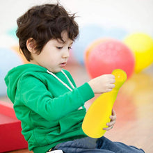 Kids enjoying bowling game set with colorful pins