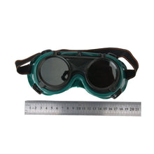 Large dark green welding goggles for safety.